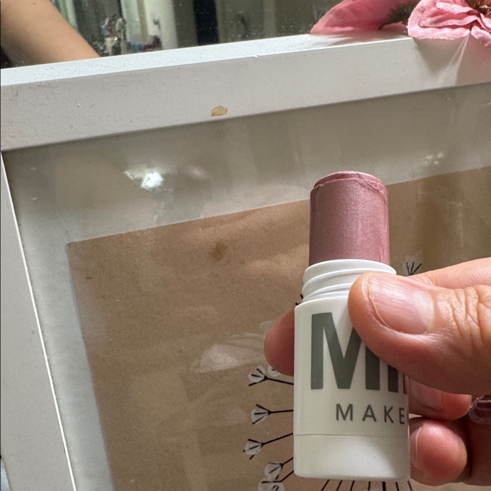Milk  Makeup Stick highlighter sparkle color between pink/brown as shown